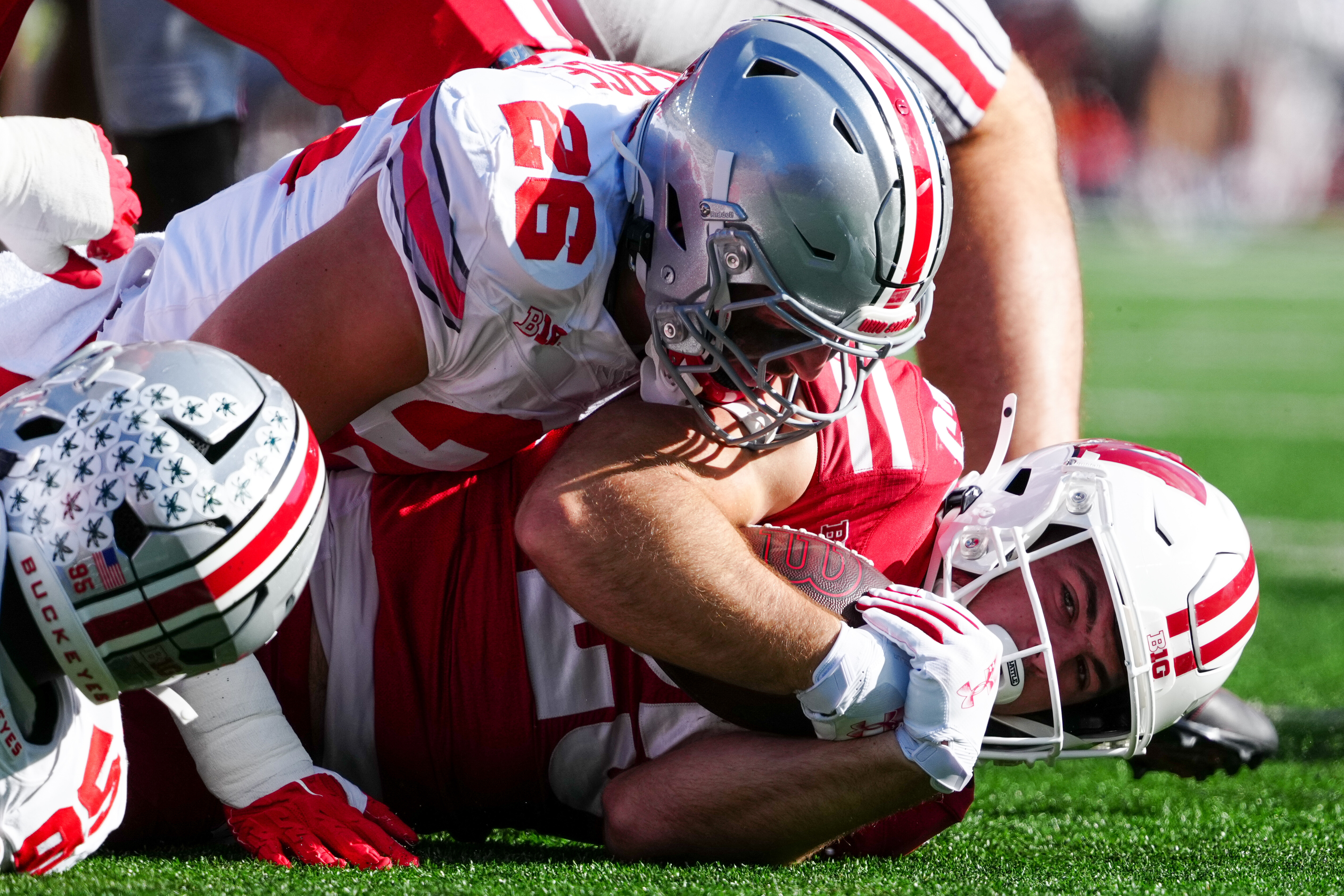 Oct 18, 2025; Madison, Wisconsin, USA; Wisconsin Badgers running back Cade Yacamelli (25) is tackled by Ohio State Buckeyes linebacker Payton Pierce (26) during the first half at Camp Randall Stadium on October 18, 2025 in Madison, Wisconsin. Photography by Ross Harried for Second Crop Sports.